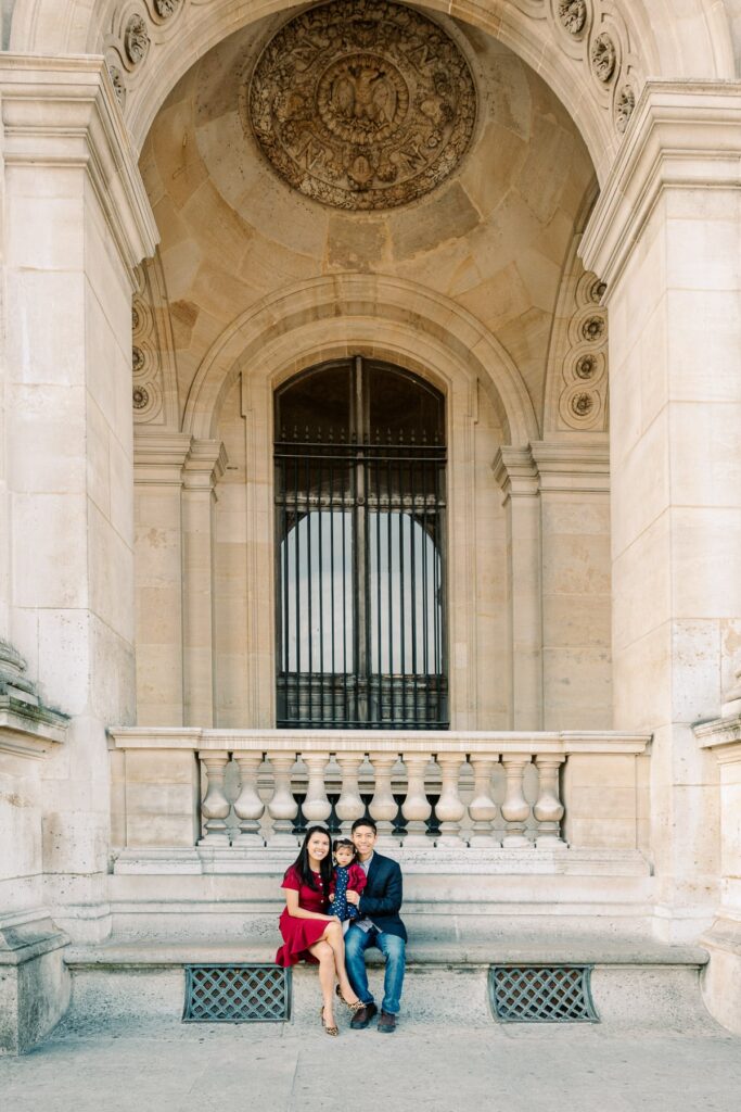 Family sitting at the Louvre in Paris France during a family session