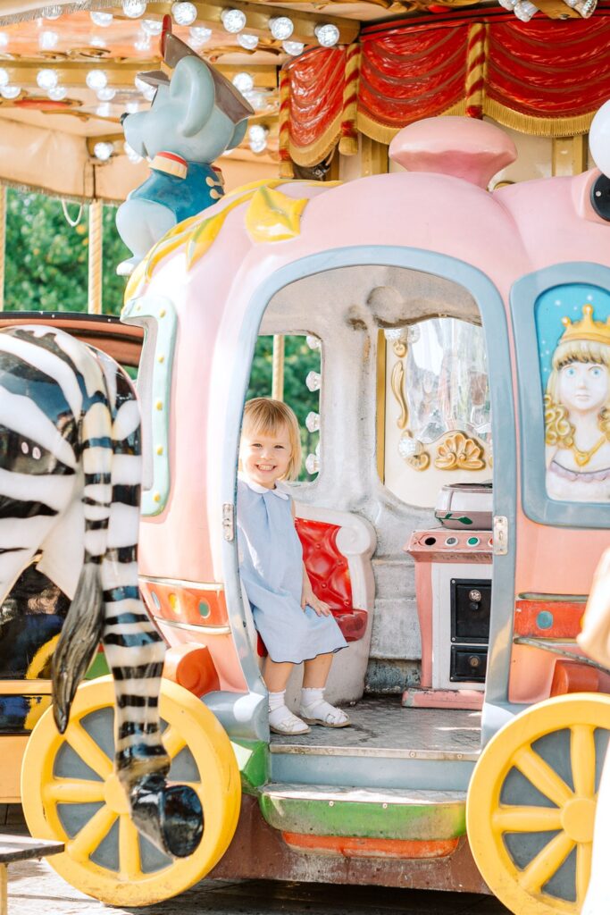 Happy girl on a carrousel in Paris France