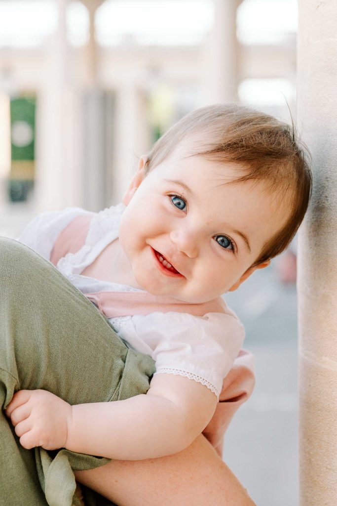 Happy baby in Palais Royal in Paris France during family photo session
